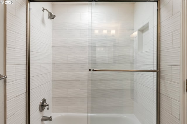 full bath with combined bath / shower with glass door