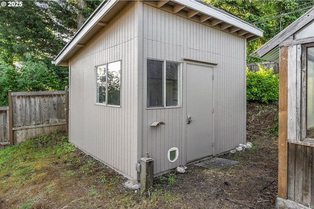 view of shed featuring fence