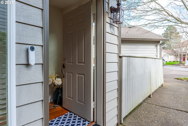 doorway to property featuring a shingled roof