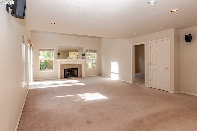 unfurnished living room with baseboards, carpet flooring, and recessed lighting