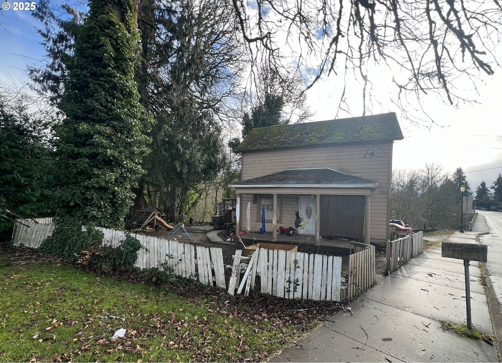 rear view of property with covered porch