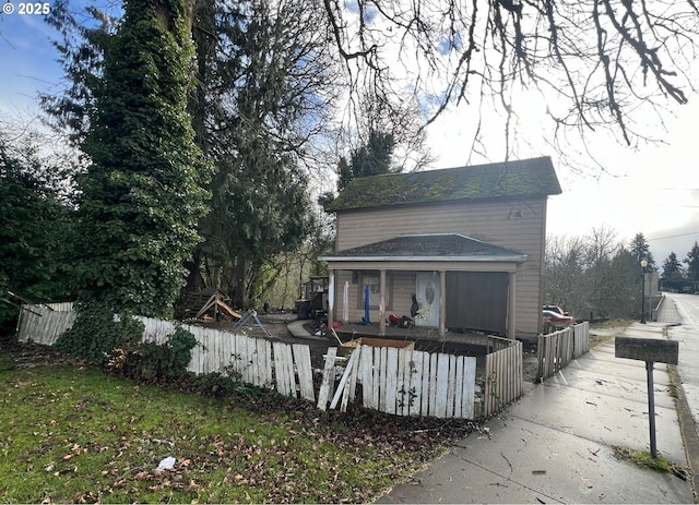 rear view of property with covered porch