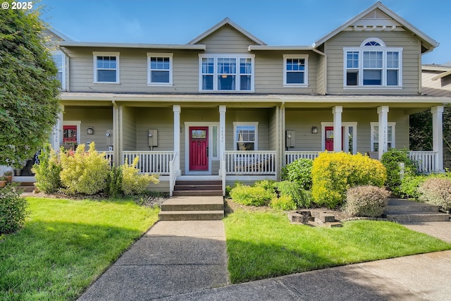 view of front of property with a front yard and a porch