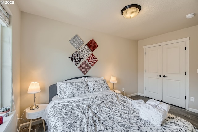 bedroom featuring dark hardwood / wood-style flooring and a closet