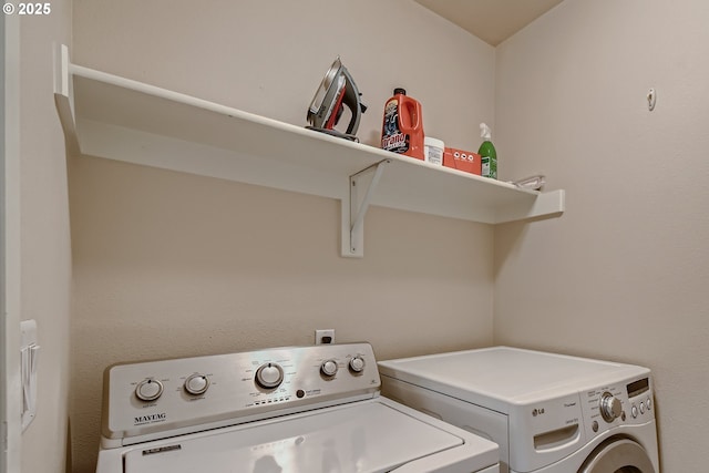 clothes washing area with washer and dryer