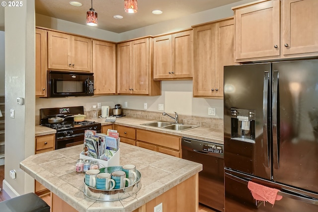 kitchen featuring decorative light fixtures, sink, light brown cabinets, and black appliances