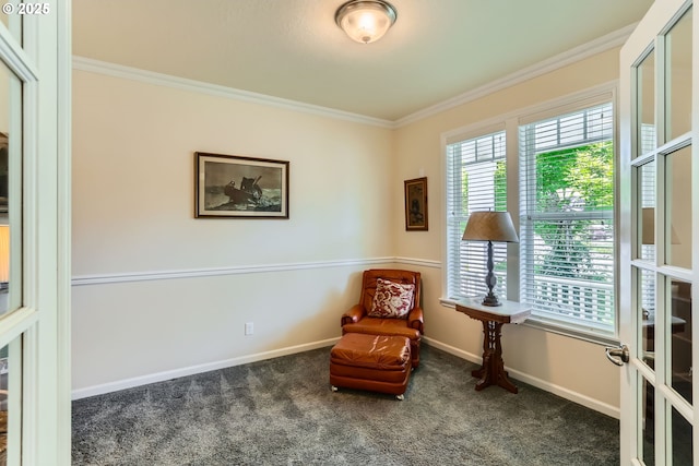 sitting room featuring crown molding, carpet floors, and baseboards