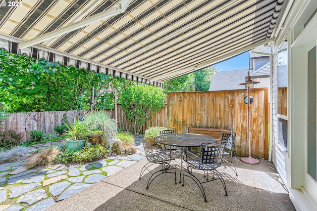 view of patio with outdoor dining space and a fenced backyard