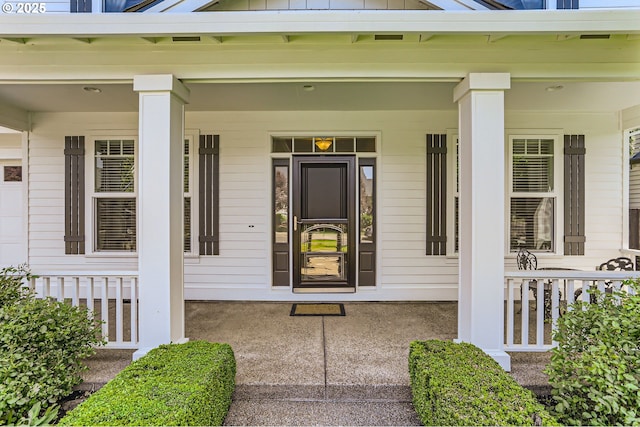 entrance to property featuring covered porch and board and batten siding