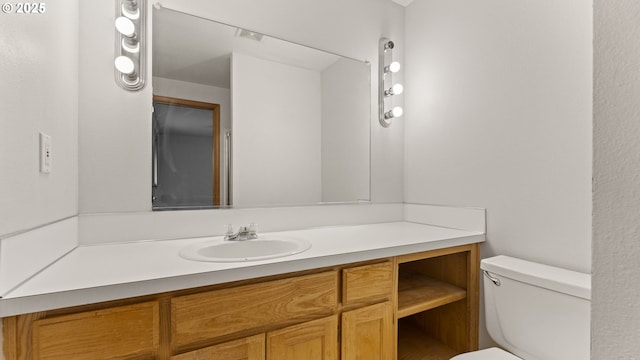 bathroom with toilet and vanity
