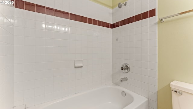bathroom featuring shower / washtub combination and toilet