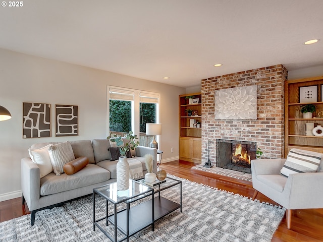 living room with hardwood / wood-style flooring and a fireplace