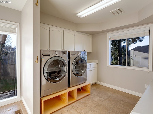 laundry area with cabinets and washing machine and dryer