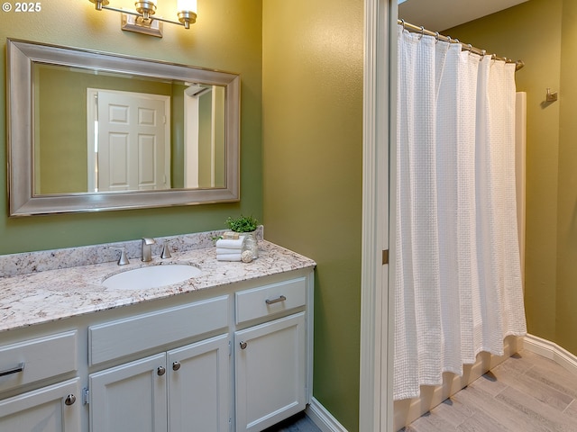 bathroom featuring vanity, hardwood / wood-style flooring, and walk in shower