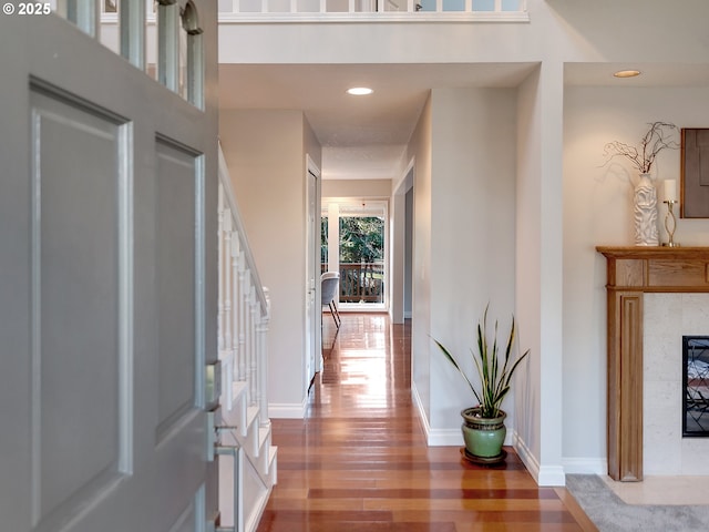 entrance foyer featuring hardwood / wood-style floors and a tile fireplace