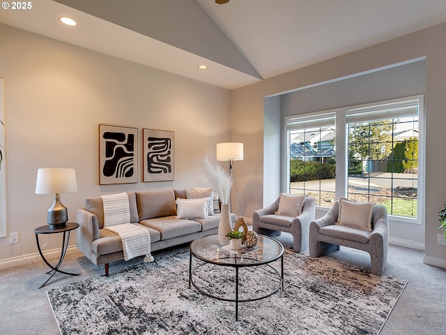 carpeted living room with vaulted ceiling