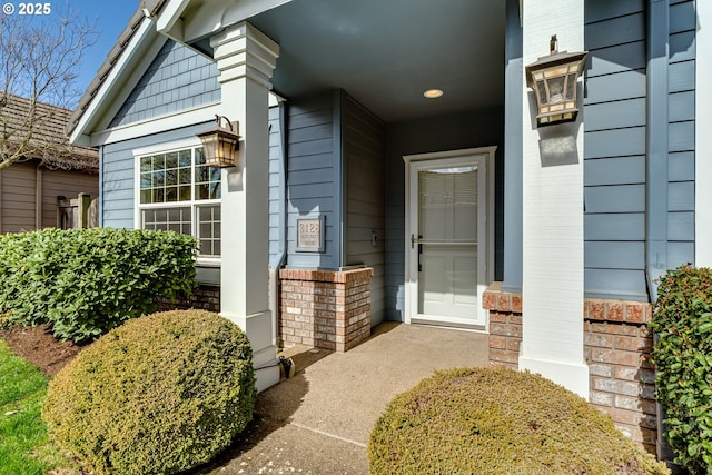 view of exterior entry with brick siding