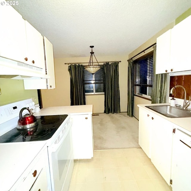 14807 NE Siskiyou Ct, Portland, OR 97230 - kitchen with electric stove, under cabinet range hood, a sink, light colored carpet, and light countertops