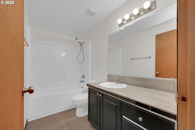 815 Bobolink Ave, Eugene, OR 97404 - bathroom featuring vanity, toilet, washtub / shower combination, and wood finished floors