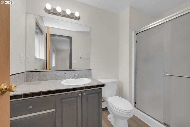 815 Bobolink Ave, Eugene, OR 97404 - bathroom featuring vanity, toilet, a shower stall, and wood finished floors