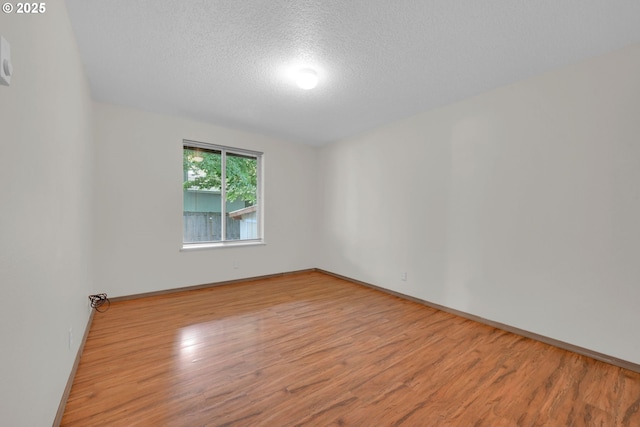 815 Bobolink Ave, Eugene, OR 97404 - spare room with a textured ceiling, wood finished floors, and baseboards