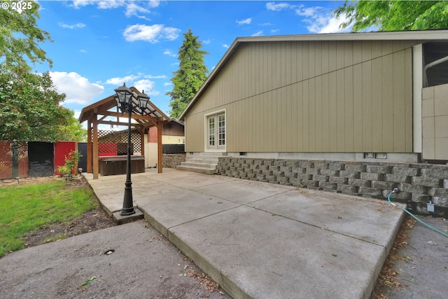 815 Bobolink Ave, Eugene, OR 97404 - view of side of property featuring a hot tub, a patio area, crawl space, and entry steps