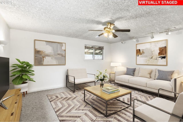 carpeted living room with a textured ceiling and ceiling fan