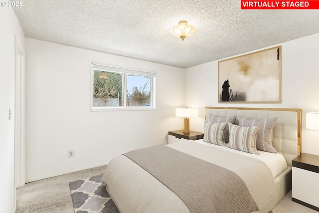 bedroom featuring carpet and a textured ceiling