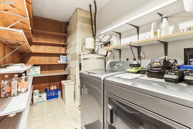 washroom featuring tile patterned floors, washing machine and clothes dryer, and laundry area