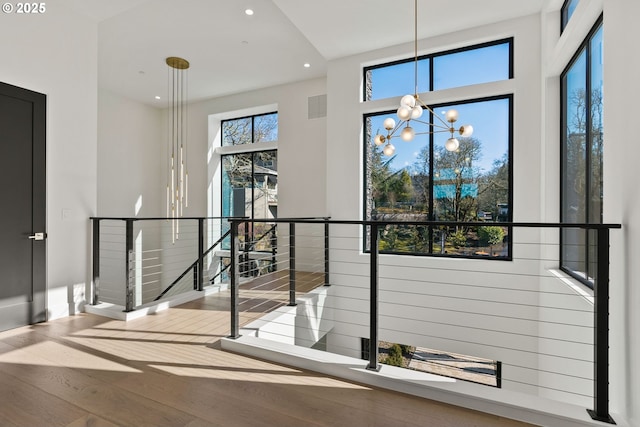 interior space with an inviting chandelier and hardwood / wood-style flooring