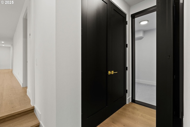 corridor with light hardwood / wood-style floors