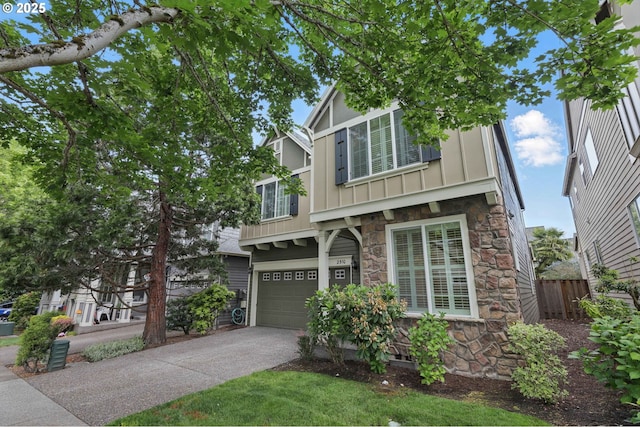 2510 NW Rogue Valley Ter, Beaverton, OR 97006 - view of front of home with stone siding, board and batten siding, driveway, and an attached garage