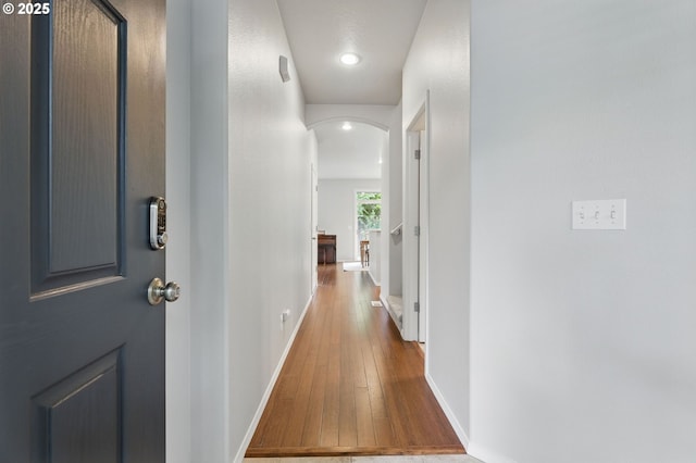 2510 NW Rogue Valley Ter, Beaverton, OR 97006 - hallway featuring hardwood / wood-style floors, arched walkways, baseboards, and recessed lighting