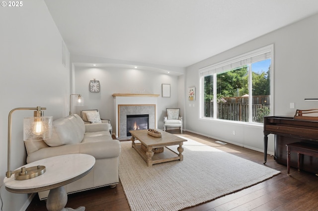 2510 NW Rogue Valley Ter, Beaverton, OR 97006 - living room with dark wood-type flooring, a fireplace, and baseboards