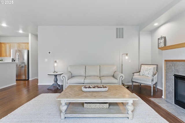 2510 NW Rogue Valley Ter, Beaverton, OR 97006 - living room with a fireplace, dark wood-style flooring, baseboards, and recessed lighting