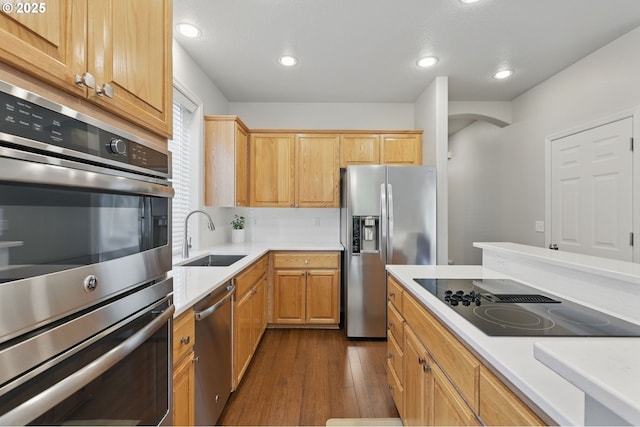 2510 NW Rogue Valley Ter, Beaverton, OR 97006 - kitchen with a sink, stainless steel appliances, dark wood-style flooring, light countertops, and recessed lighting