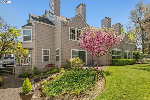 8540 SW Curry Dr Unit D, Wilsonville, OR 97070 - back of house featuring a lawn, ac unit, and a chimney
