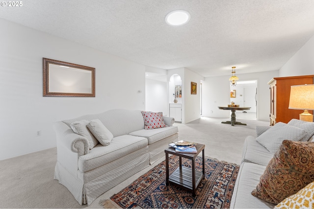 living room featuring light colored carpet and a textured ceiling