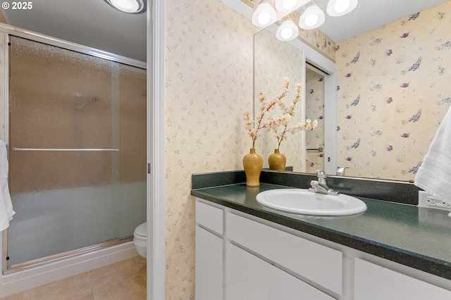 bathroom featuring an enclosed shower, vanity, tile patterned flooring, and toilet