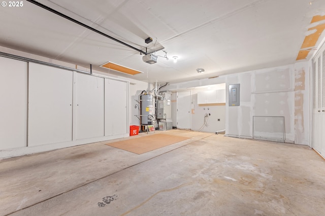 garage with a garage door opener, electric panel, and strapped water heater