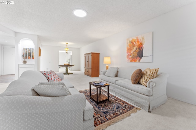 carpeted living room featuring a textured ceiling