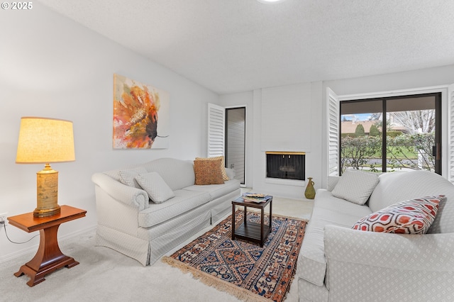 living room featuring carpet and a textured ceiling