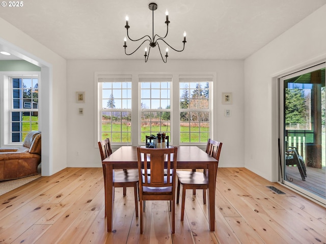 92041 Carmen Creek Rd, Astoria, OR 97103 - dining area with light wood finished floors and a chandelier