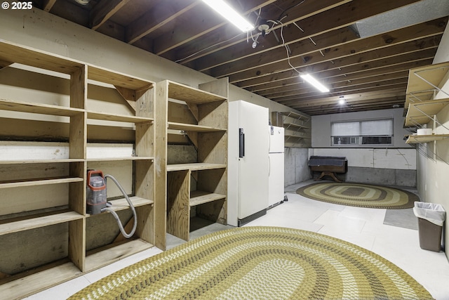 unfinished below grade area with freestanding refrigerator