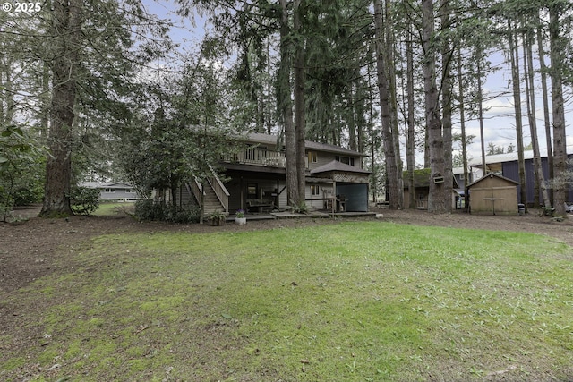 view of yard featuring an outdoor structure, a wooden deck, a storage unit, and stairs