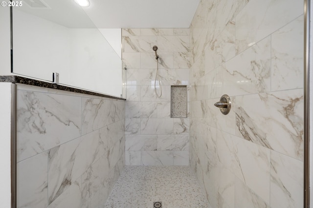full bathroom featuring tiled shower