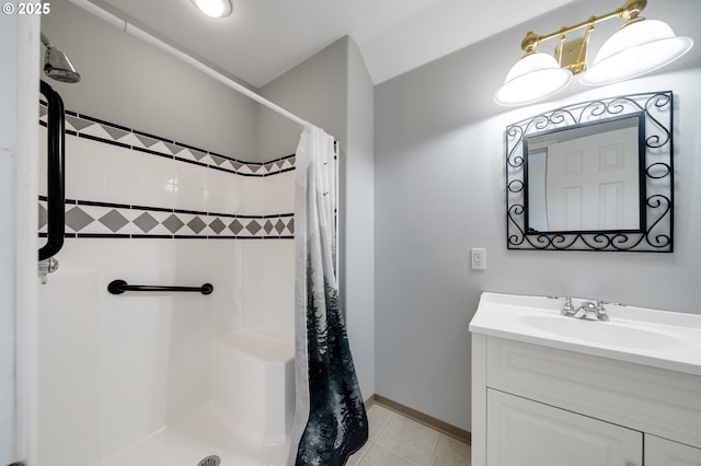 bathroom featuring a shower with curtain, baseboards, tile patterned flooring, and vanity