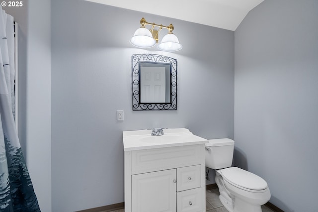 bathroom with tile patterned floors, toilet, vanity, and baseboards
