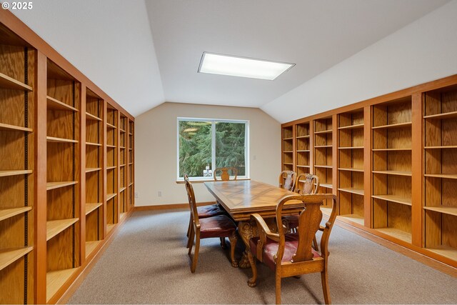 dining space with baseboards, vaulted ceiling, and carpet