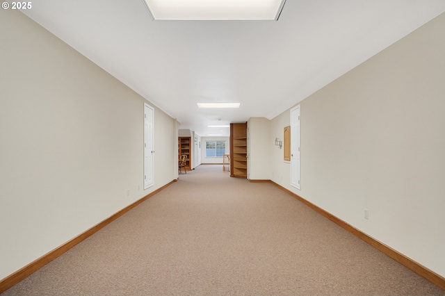 empty room with light carpet and baseboards